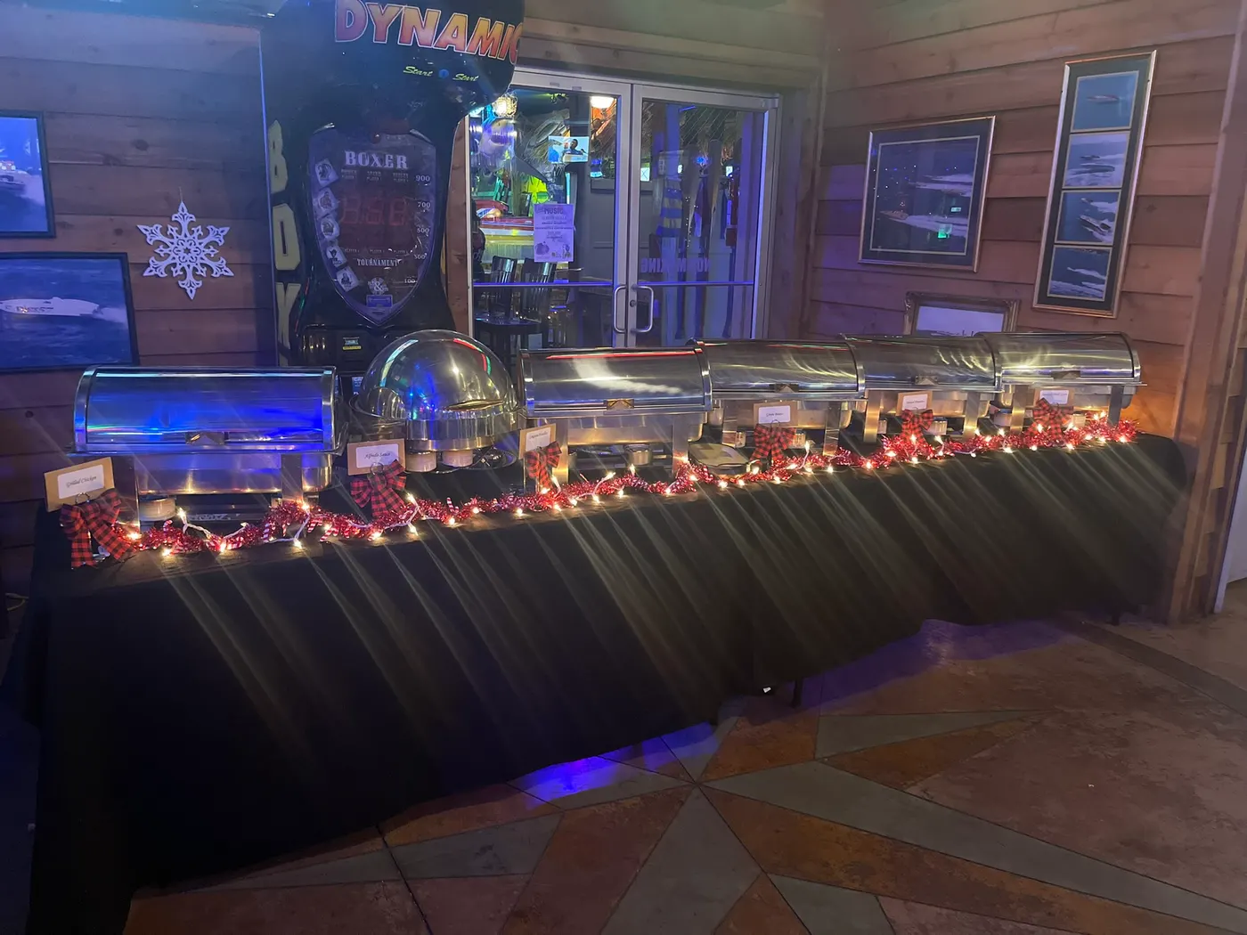 Buffet tables laid end to end along the panelled wall under the boxing machine