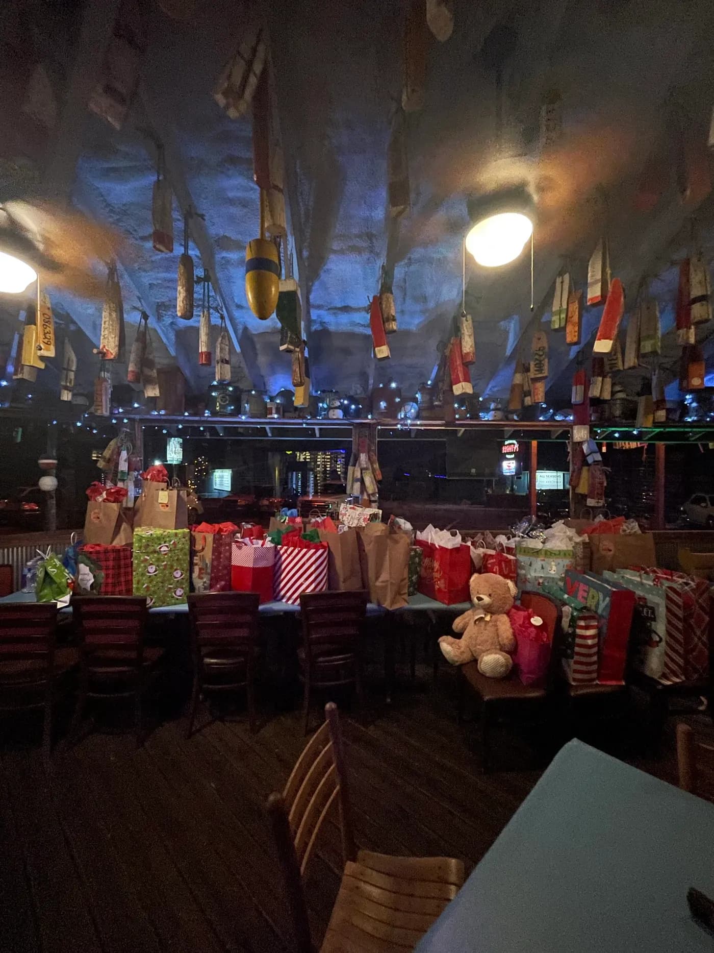 Gift bags and wrapped presents stacked the length of the bar
